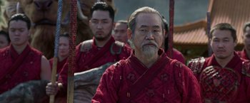 Movie still from “Shang-Chi and the Legend of the Ten Rings” (2021), directed by Destin Daniel Cretton – A group of men in traditional chinese garb; Medium shot, Over the shoulder angle