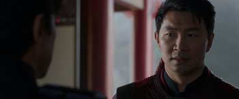 Movie still from “Shang-Chi and the Legend of the Ten Rings” (2021), directed by Destin Daniel Cretton – A person wearing a sweater; Close Up shot, Over the shoulder angle
