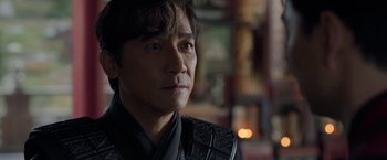 Movie still from “Shang-Chi and the Legend of the Ten Rings” (2021), directed by Destin Daniel Cretton – A person wearing a black jacket; Close Up shot, Over the shoulder angle