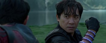 Movie still from “Shang-Chi and the Legend of the Ten Rings” (2021), directed by Destin Daniel Cretton – A person wearing a leather jacket; Close Up shot, Over the shoulder angle