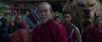 Movie still from “Shang-Chi and the Legend of the Ten Rings” (2021), directed by Destin Daniel Cretton – A man in a red jacket holding an arrow; Close Up shot, Over the shoulder angle