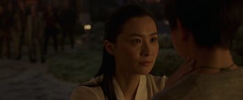 Movie still from “Shang-Chi and the Legend of the Ten Rings” (2021), directed by Destin Daniel Cretton – A person wearing a white shirt; Close Up shot, Over the shoulder angle