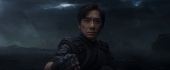 Movie still from “Shang-Chi and the Legend of the Ten Rings” (2021), directed by Destin Daniel Cretton – A person holding something in his hand; Close Up shot, Over the shoulder angle