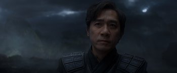 Movie still from “Shang-Chi and the Legend of the Ten Rings” (2021), directed by Destin Daniel Cretton – A person wearing a black outfit; Close Up shot, Over the shoulder angle