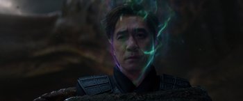 Movie still from “Shang-Chi and the Legend of the Ten Rings” (2021), directed by Destin Daniel Cretton – A man in a black jacket is looking at the camera; Close Up shot, Over the shoulder angle