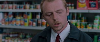 Movie still from “Shaun of the Dead” (2004), directed by Edgar Wright – A person wearing a suit and tie; Close Up shot, Low angle