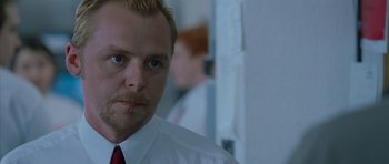 Movie still from “Shaun of the Dead” (2004), directed by Edgar Wright – A person wearing a white shirt and a red tie; Close Up shot, Over the shoulder angle