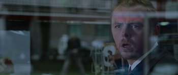Movie still from “Shaun of the Dead” (2004), directed by Edgar Wright – A person looking through a window; Close Up shot, Low angle