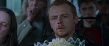 Movie still from “Shaun of the Dead” (2004), directed by Edgar Wright – A person with a flower in his hand; Close Up shot, Over the shoulder angle