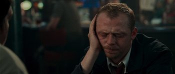 Movie still from “Shaun of the Dead” (2004), directed by Edgar Wright – A person holding his head with his hands; Close Up shot, Over the shoulder angle