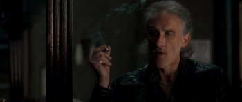 Movie still from “Shaun of the Dead” (2004), directed by Edgar Wright – An older man smoking a cigarette in front of a mirror; Close Up shot, Over the shoulder angle