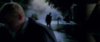 Movie still from “Shaun of the Dead” (2004), directed by Edgar Wright – A man walking down the street in the rain; Close Up shot, Over the shoulder angle