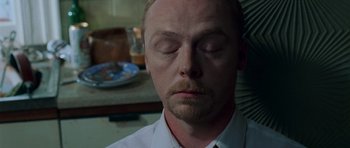 Movie still from “Shaun of the Dead” (2004), directed by Edgar Wright – A person with his eyes closed; Close Up shot, High angle