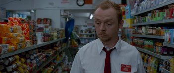 Movie still from “Shaun of the Dead” (2004), directed by Edgar Wright – A man in a white shirt and a red neck tie; Medium shot, High angle