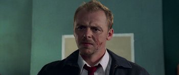 Movie still from “Shaun of the Dead” (2004), directed by Edgar Wright – A person wearing a suit and tie; Close Up shot, Low angle
