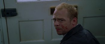 Movie still from “Shaun of the Dead” (2004), directed by Edgar Wright – A person with blood on his face; Close Up shot, Low angle