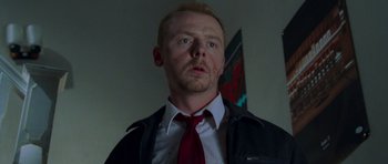 Movie still from “Shaun of the Dead” (2004), directed by Edgar Wright – A person wearing a suit and tie; Close Up shot, Low angle