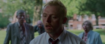 Movie still from “Shaun of the Dead” (2004), directed by Edgar Wright – A man in a white shirt and a red tie; Close Up shot, Over the shoulder angle