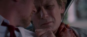 Movie still from “Shaun of the Dead” (2004), directed by Edgar Wright – A person with his hand under his chin; Close Up shot, Over the shoulder angle