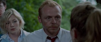 Movie still from “Shaun of the Dead” (2004), directed by Edgar Wright – A person wearing a shirt and a tie; Close Up shot, Over the shoulder angle