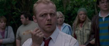 Movie still from “Shaun of the Dead” (2004), directed by Edgar Wright – A person wearing a shirt and tie; Close Up shot, Over the shoulder angle