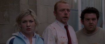 Movie still from “Shaun of the Dead” (2004), directed by Edgar Wright – A man and a woman standing next to each other; Close Up shot, Over the shoulder angle