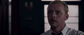 Movie still from “Shaun of the Dead” (2004), directed by Edgar Wright – A person wearing a shirt and bow tie; Close Up shot, Over the shoulder angle