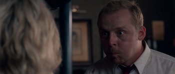 Movie still from “Shaun of the Dead” (2004), directed by Edgar Wright – A person looking at a mirror; Close Up shot, Over the shoulder angle