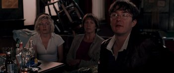 Movie still from “Shaun of the Dead” (2004), directed by Edgar Wright – A group of people sitting at a table; Medium shot, Over the shoulder angle