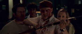 Movie still from “Shaun of the Dead” (2004), directed by Edgar Wright – A group of people with knives and blood on their faces; Close Up shot, Over the shoulder angle