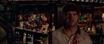 Movie still from “Shaun of the Dead” (2004), directed by Edgar Wright – A man with a red bandage on his head; Close Up shot, Over the shoulder angle