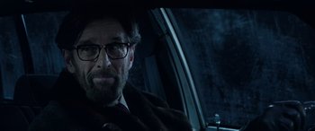 Movie still from “Shazam!” (2019), directed by David F. Sandberg – A man with a beard and glasses sitting in a car; Close Up shot, Over the shoulder angle