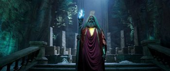 Movie still from “Shazam!” (2019), directed by David F. Sandberg – An image of a man with a long beard holding a staff; Wide shot, Low angle