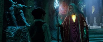 Movie still from “Shazam!” (2019), directed by David F. Sandberg – A man with a long beard holding a staff in his hand; Medium shot, Over the shoulder angle