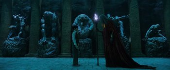 Movie still from “Shazam!” (2019), directed by David F. Sandberg – Two people standing in front of a stone wall; Wide shot, Low angle