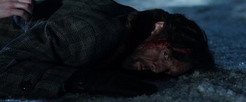 Movie still from “Shazam!” (2019), directed by David F. Sandberg – A man with a bloody face laying on the ground; Close Up shot, High angle