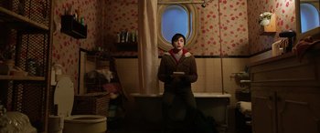 Movie still from “Shazam!” (2019), directed by David F. Sandberg – A man sitting on a bench in a bathroom; Medium shot, High angle