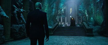 Movie still from “Shazam!” (2019), directed by David F. Sandberg – A man standing in front of an entrance to a building; Wide shot, Over the shoulder angle