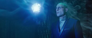 Movie still from “Shazam!” (2019), directed by David F. Sandberg – A man in a suit and tie looking up at a fireworks display; Medium shot, Low angle