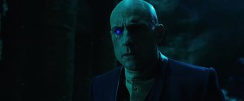 Movie still from “Shazam!” (2019), directed by David F. Sandberg – A bald man with a blue light on his face; Close Up shot, Over the shoulder angle