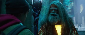 Movie still from “Shazam!” (2019), directed by David F. Sandberg – A man with a long beard is holding a staff; Medium shot, Over the shoulder angle