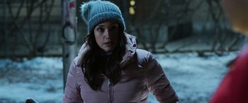 Movie still from “Shazam!” (2019), directed by David F. Sandberg – A woman wearing a pink jacket and a blue hat; Close Up shot, Over the shoulder angle