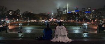 Movie still from “Shazam!” (2019), directed by David F. Sandberg – Two people sitting on a bench looking out at a city at night; Extreme Wide shot, High angle