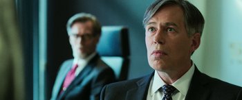 Movie still from “Shazam!” (2019), directed by David F. Sandberg – A man in a suit and tie next to another man in a suit and tie; Close Up shot, Over the shoulder angle