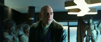 Movie still from “Shazam!” (2019), directed by David F. Sandberg – A bald man wearing a leather jacket with a fur collar; Close Up shot, Low angle