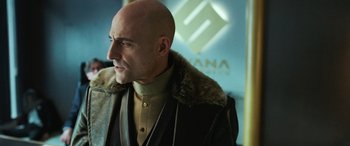 Movie still from “Shazam!” (2019), directed by David F. Sandberg – A man with bald head wearing a coat and tie; Close Up shot, Over the shoulder angle