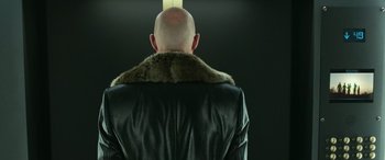 Movie still from “Shazam!” (2019), directed by David F. Sandberg – A bald man wearing a black leather jacket and a fur collar; Close Up shot, Low angle