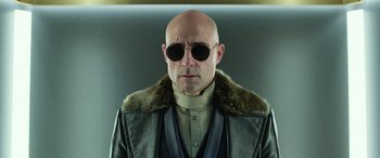 Movie still from “Shazam!” (2019), directed by David F. Sandberg – A bald man wearing sunglasses and a leather jacket; Close Up shot, Low angle