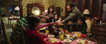 Movie still from “Shazam!” (2019), directed by David F. Sandberg – A group of people sitting around a dinner table; Medium shot, High angle