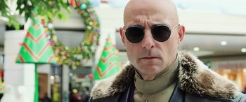 Movie still from “Shazam!” (2019), directed by David F. Sandberg – A bald man wearing sunglasses and a leather jacket; Close Up shot, Low angle